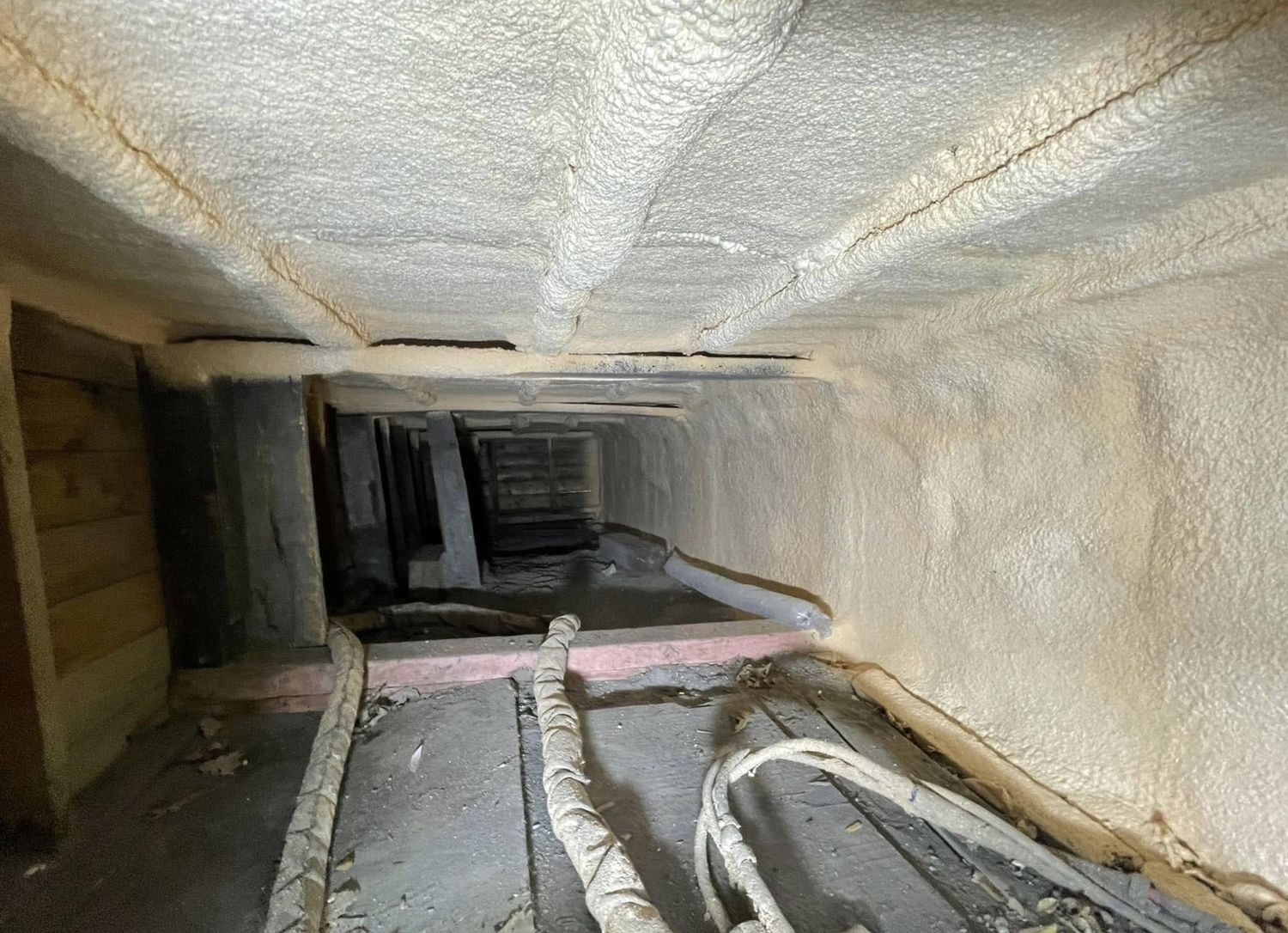 Attic eave cavity air-sealed with spray foam where the roof meets the exterior wall