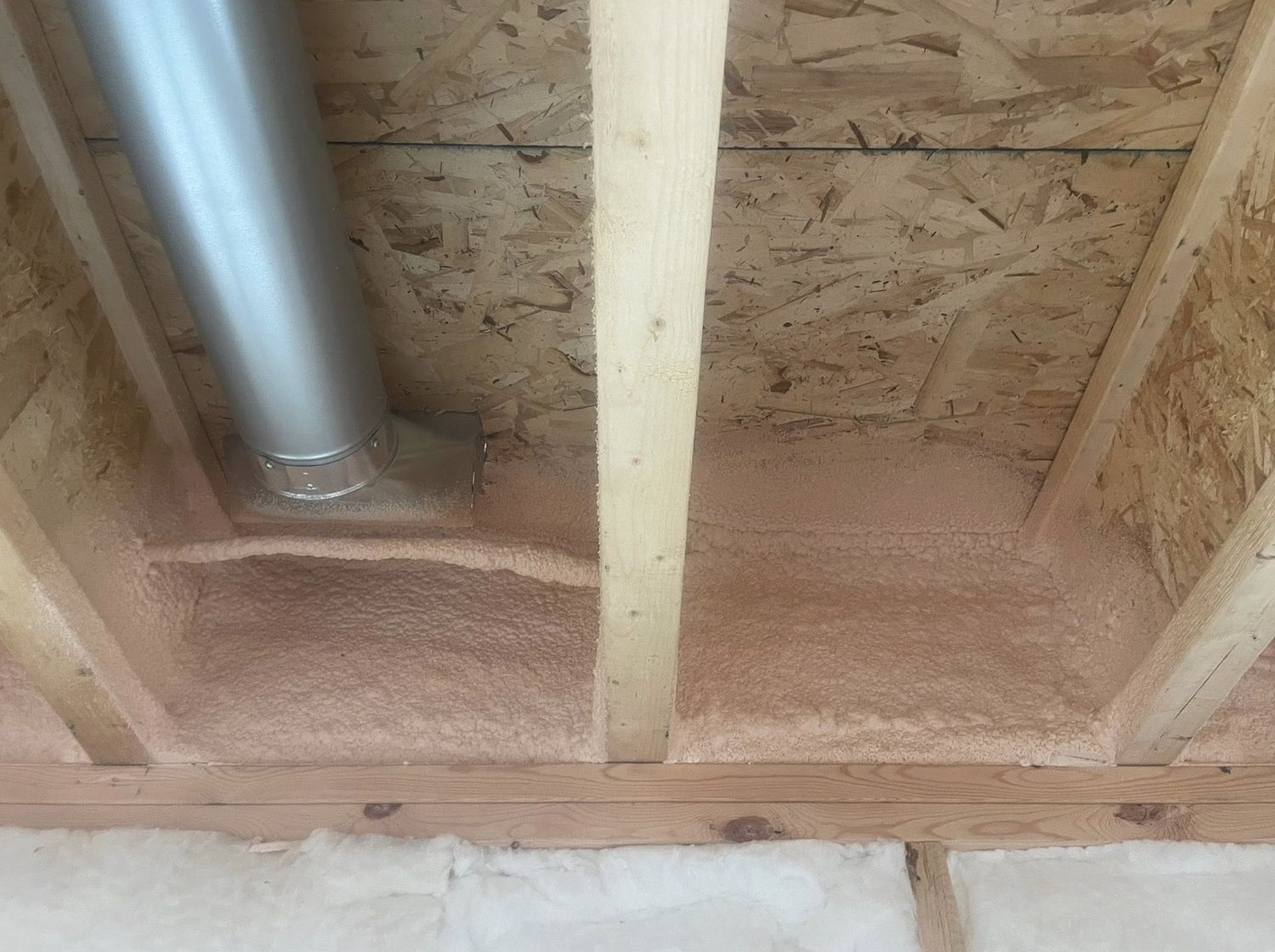 Spray foam sealing around ductwork penetrations at the rim joist